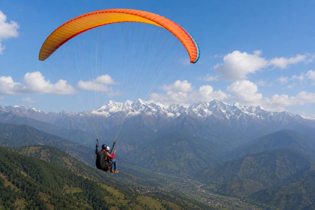 Tandem paragliding at Bir Billing Himachal Pradesh — view of Dhauladhar range from above
