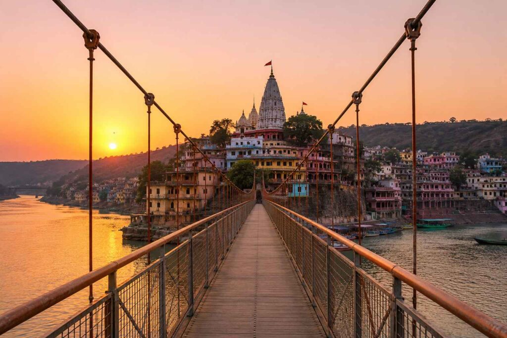 Suspension bridge leading to Omkareshwar temple on Mandhata island at dawn